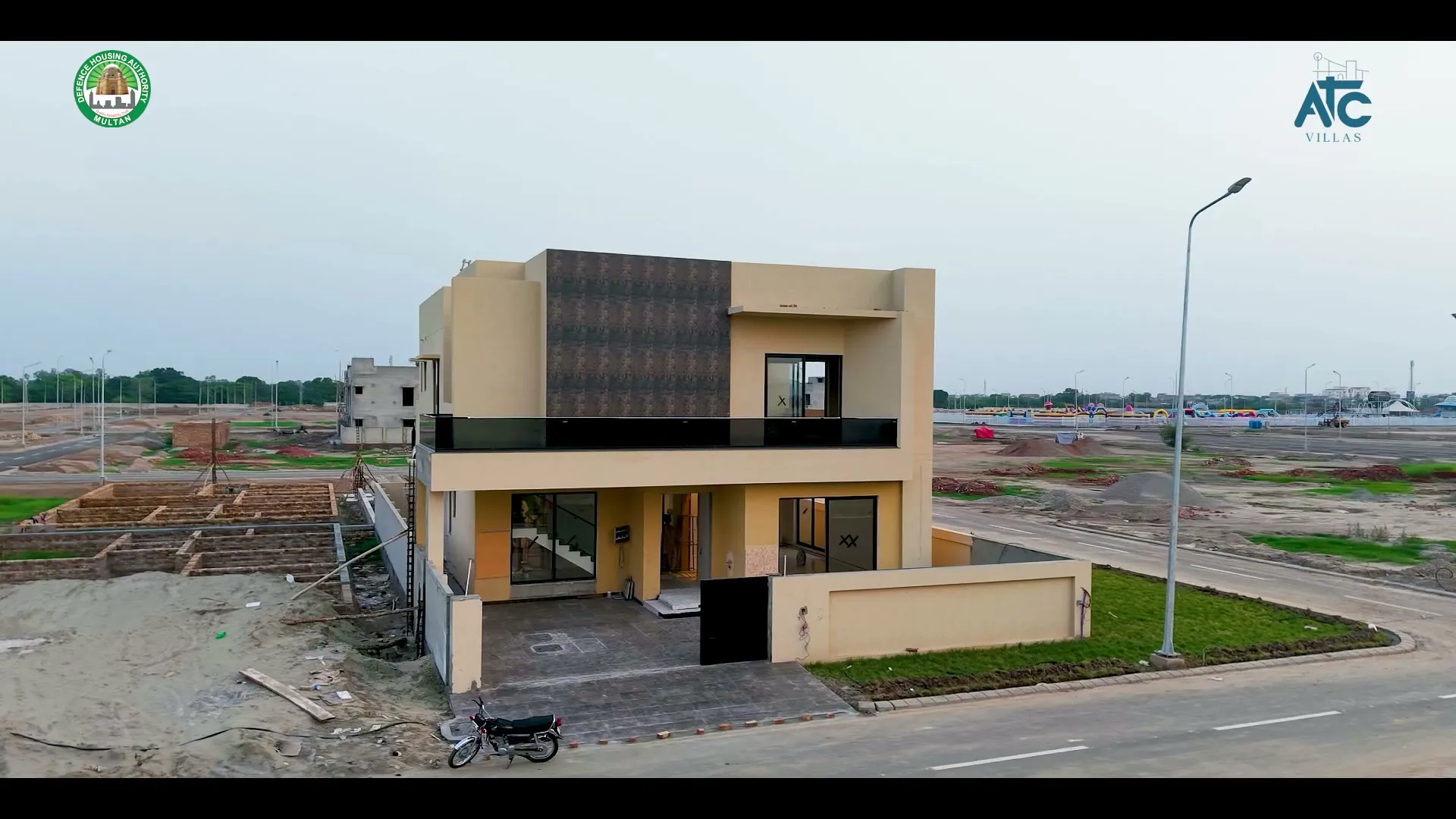 A completed villa at ATC Villas with construction in progress around it, August 2026